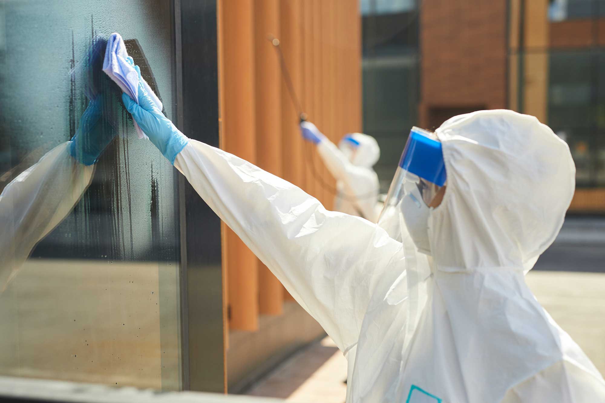 female-worker-cleaning-windows-outdoors